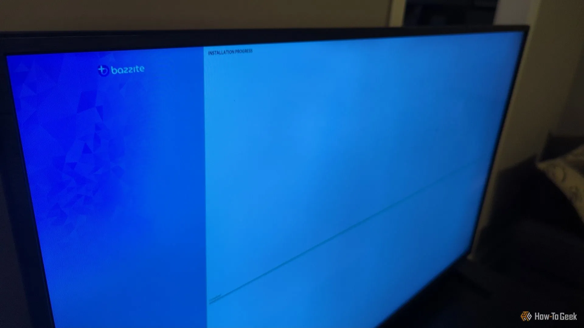 A living room TV with a Bazzite installation screen visible.