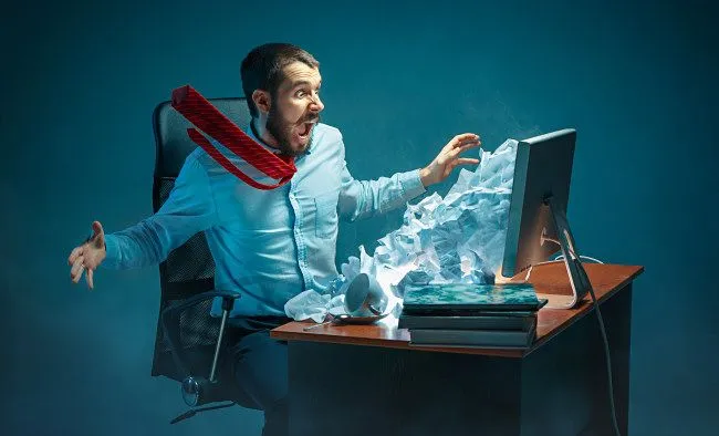 Hình minh họa một người đàn ông phản ứng với thư rác (spam) tràn ngập trên màn hình máy tính của mình