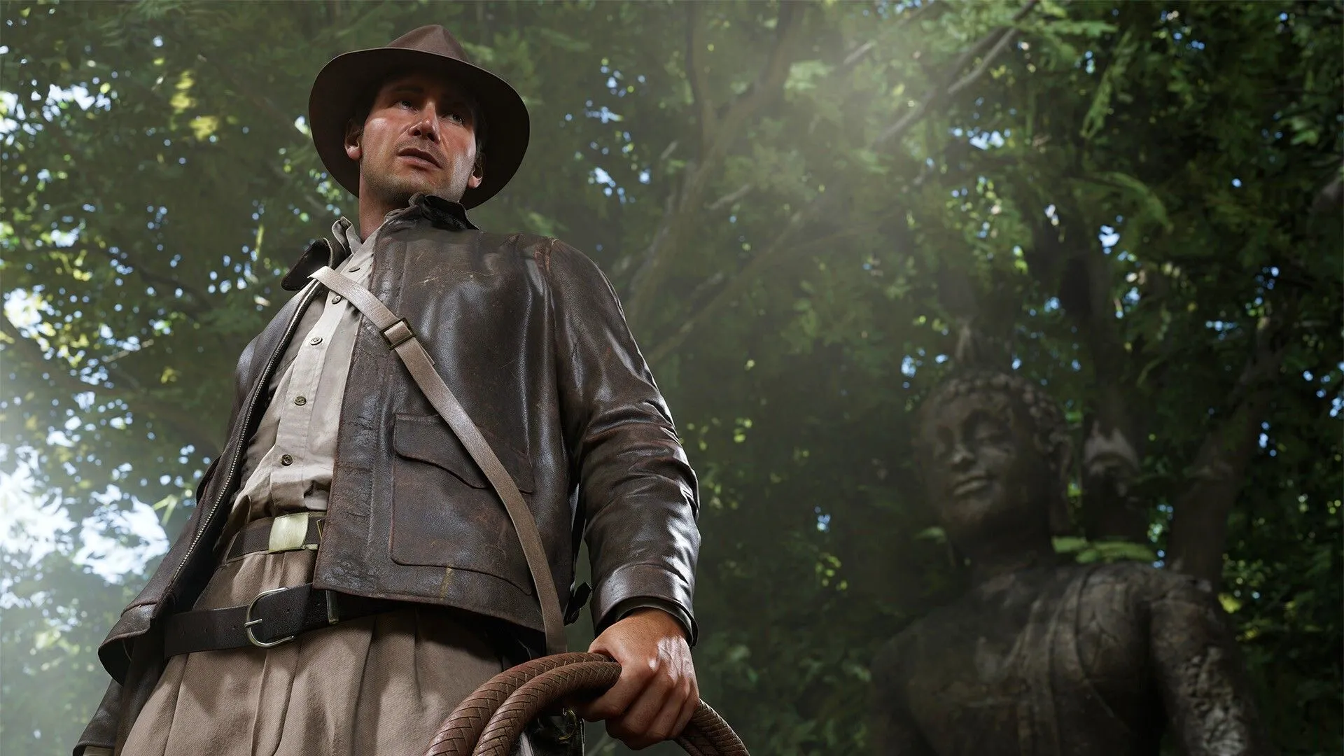 Indiana Jones sử dụng dây thòng lọng bên cạnh một bức tượng cổ trong trò chơi phiêu lưu The Great Circle.