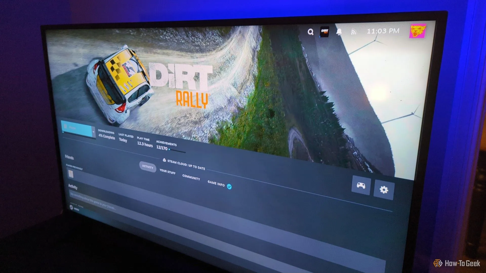 Steam on a TV screen installing the game Dirt Rally.